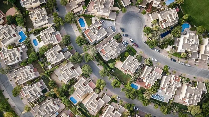 Aerial view of a Singapore cluster housing estate with private pools, shared driveways, and landscaped grounds